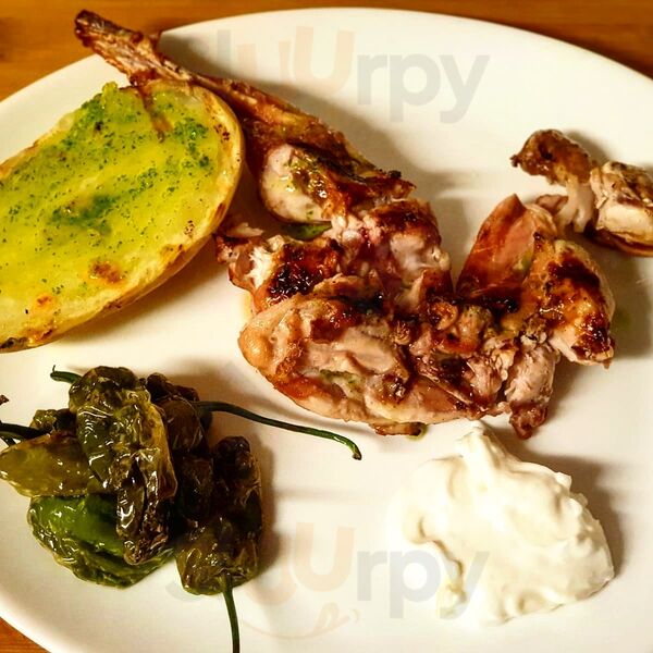 Grilled rabbit (conejo) with roasted potato and pimientos de Padrón