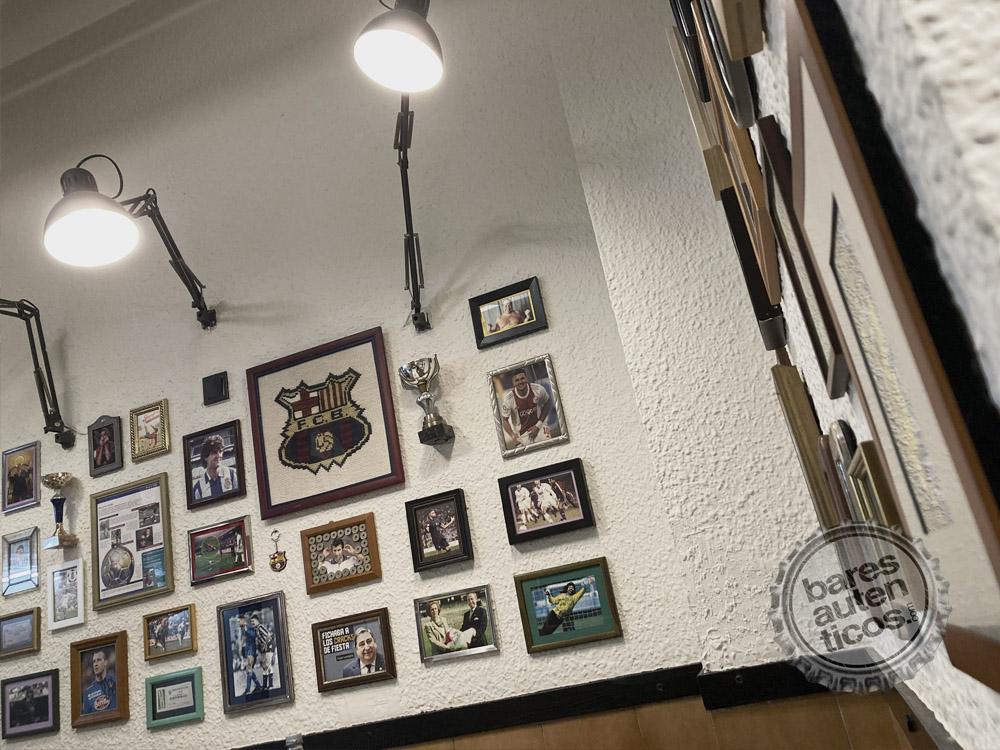 Wall of FC Barcelona memorabilia — crochet Barça crest, Maradona photo, trophies